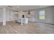 Well-lit kitchen featuring white cabinets, a spacious island, and stainless-steel appliances at 127 Felicity Pike, Locust Grove, GA 30248