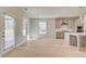 Bright kitchen showcasing hardwood floors, island seating, and stainless steel appliances at 127 Felicity Pike, Locust Grove, GA 30248