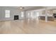 Spacious open-concept with fireplace, hardwood flooring, and seamless transition to the kitchen at 127 Felicity Pike, Locust Grove, GA 30248