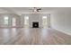 Bright living room showcasing a modern fireplace, hardwood floors, and access to the outdoors at 127 Felicity Pike, Locust Grove, GA 30248