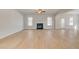 Open concept living room with hardwood floors, fireplace, and multiple windows at 127 Felicity Pike, Locust Grove, GA 30248