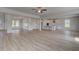 Expansive living room with hardwood floors, large windows, and seamless flow into the modern kitchen at 127 Felicity Pike, Locust Grove, GA 30248