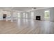 Open-concept living room featuring hardwood flooring, a fireplace, and large windows with natural light at 127 Felicity Pike, Locust Grove, GA 30248