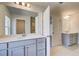Elegant bathroom features double sinks, a large mirror, and access to a walk-in closet and shower at 127 Felicity Pike, Locust Grove, GA 30248