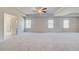 Spacious main bedroom with neutral carpet and tray ceiling, multiple windows and ceiling fan at 127 Felicity Pike, Locust Grove, GA 30248