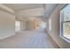 Spacious main bedroom with neutral carpet, tray ceiling, multiple windows and access to an ensuite bathroom at 127 Felicity Pike, Locust Grove, GA 30248