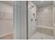 Contemporary walk-in shower with tiled walls, built-in seat, and sleek fixtures next to the walk-in closet at 127 Felicity Pike, Locust Grove, GA 30248