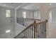 View of staircase featuring wrought iron spindles and a chandelier at 127 Felicity Pike, Locust Grove, GA 30248