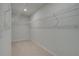 Spacious walk-in closet with carpet flooring and white wire shelving for optimal storage and organization at 127 Felicity Pike, Locust Grove, GA 30248