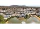 Community aerial showcasing townhomes surrounding a pond with a fountain, near roads and lush greenery at 1741 Stanwood Dr, Kennesaw, GA 30152