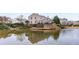 Back exterior of modern townhomes reflected in a serene pond with manicured landscaping at 1741 Stanwood Dr, Kennesaw, GA 30152