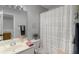 Bathroom featuring a shower with a white ruffled shower curtain and vanity mirror at 1741 Stanwood Dr, Kennesaw, GA 30152