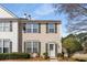 Charming two-story townhome featuring light siding, green shutters, and well-maintained landscaping at 1741 Stanwood Dr, Kennesaw, GA 30152