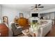 This living room offers a comfortable chair, fireplace, open floor plan, and hardwood floors at 1741 Stanwood Dr, Kennesaw, GA 30152