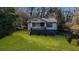 View of the front yard of the home, showing the lawn, trees, and exterior features at 2183 Rhinehill Se Rd, Atlanta, GA 30315