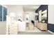 Cozy living area with white sofa, blue accents, and a work area to maximize the space at 2445 Livi Ln, Buford, GA 30519