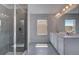Bright bathroom with tiled shower, dual sinks and a large vanity with ample space at 237 Chiswick Loop, Stockbridge, GA 30281