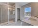 Bathroom featuring a tiled shower, dual sinks, and natural light from a window at 237 Chiswick Loop, Stockbridge, GA 30281