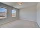Neutral bedroom features plush carpet, two windows, and lots of natural light at 237 Chiswick Loop, Stockbridge, GA 30281