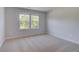 Bedroom featuring carpeted floor and natural light from two windows at 237 Chiswick Loop, Stockbridge, GA 30281