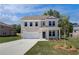 Two-story home features a manicured lawn, long driveway, and covered front porch at 237 Chiswick Loop, Stockbridge, GA 30281
