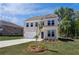 Two-story home with a two-car garage, charming front yard, and a long driveway at 237 Chiswick Loop, Stockbridge, GA 30281
