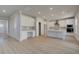 Bright, open kitchen boasts white cabinets, an island with sink, stainless appliances, and a walk-in pantry at 237 Chiswick Loop, Stockbridge, GA 30281