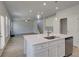 Kitchen island with stainless dishwasher and sink with views to backyard and Gathering room at 237 Chiswick Loop, Stockbridge, GA 30281