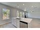 Kitchen island with stainless dishwasher and sink with views to backyard and Gathering room at 237 Chiswick Loop, Stockbridge, GA 30281