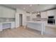Bright, open kitchen boasts white cabinets, an island with sink, stainless appliances, and a walk-in pantry at 237 Chiswick Loop, Stockbridge, GA 30281