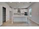 Bright, open kitchen boasts white cabinets, an island with sink, stainless appliances, and a walk-in pantry at 237 Chiswick Loop, Stockbridge, GA 30281