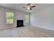 Bright Living Room featuring luxury vinyl plank flooring, a fireplace, and two windows at 237 Chiswick Loop, Stockbridge, GA 30281