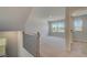 Open loft space with natural light showcases neutral carpet and access to bedrooms at 237 Chiswick Loop, Stockbridge, GA 30281