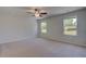 Spacious main bedroom featuring a ceiling fan and natural light from two large windows at 237 Chiswick Loop, Stockbridge, GA 30281