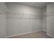 Walk-in closet boasts ample storage space with built-in shelving and carpeted flooring at 237 Chiswick Loop, Stockbridge, GA 30281