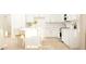 Modern kitchen with white cabinets, stainless steel appliances, a kitchen island, and light wood floors at 2451 Livi Ln, Buford, GA 30519