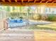 View of backyard with wooden deck, patio set, and lush landscaping at 5206 Westhill Nw Dr, Norcross, GA 30071