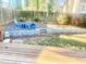 Backyard with wooden deck, patio set, and landscaping at 5206 Westhill Nw Dr, Norcross, GA 30071