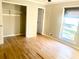 Bedroom featuring hardwood floors, closet, and a window at 5206 Westhill Nw Dr, Norcross, GA 30071