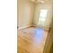 Bright bedroom with hardwood floors and window overlooking nature at 5206 Westhill Nw Dr, Norcross, GA 30071