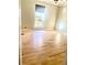 Bedroom with hardwood floors, window, and neutral color scheme at 5206 Westhill Nw Dr, Norcross, GA 30071