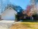 Charming home featuring an attached two-car garage and well-maintained landscaping at 5206 Westhill Nw Dr, Norcross, GA 30071