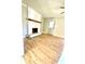 Bright living room with hardwood floors, fireplace, and ceiling fan at 5206 Westhill Nw Dr, Norcross, GA 30071
