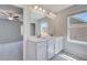 Bright bathroom featuring double vanity, large mirror, recessed lighting, and window views at 132 Dalston Cv, Stockbridge, GA 30281