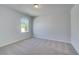 Bedroom featuring neutral carpet, a large window, and light gray walls at 132 Dalston Cv, Stockbridge, GA 30281