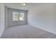 Bedroom featuring neutral carpet, a large window, and light gray walls at 132 Dalston Cv, Stockbridge, GA 30281