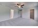 Inviting bedroom with neutral tones, soft carpet, ceiling fan, and ample natural light from windows at 132 Dalston Cv, Stockbridge, GA 30281