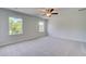 Spacious bedroom featuring neutral walls, plush carpet, and a ceiling fan for comfort and style at 132 Dalston Cv, Stockbridge, GA 30281