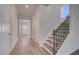 Hallway and staircase with wood floors and white trim, bathed in natural light at 132 Dalston Cv, Stockbridge, GA 30281
