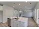 Bright kitchen with stainless steel dishwasher, center island with sink, and an open floor plan at 132 Dalston Cv, Stockbridge, GA 30281